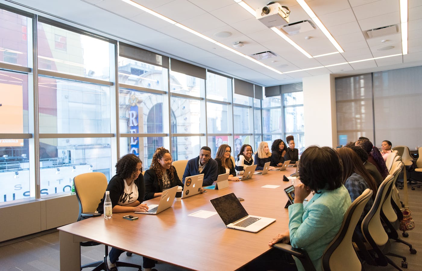 Enterprise office with analysts and IT staff using Microsoft 365 E3 across multiple screens.